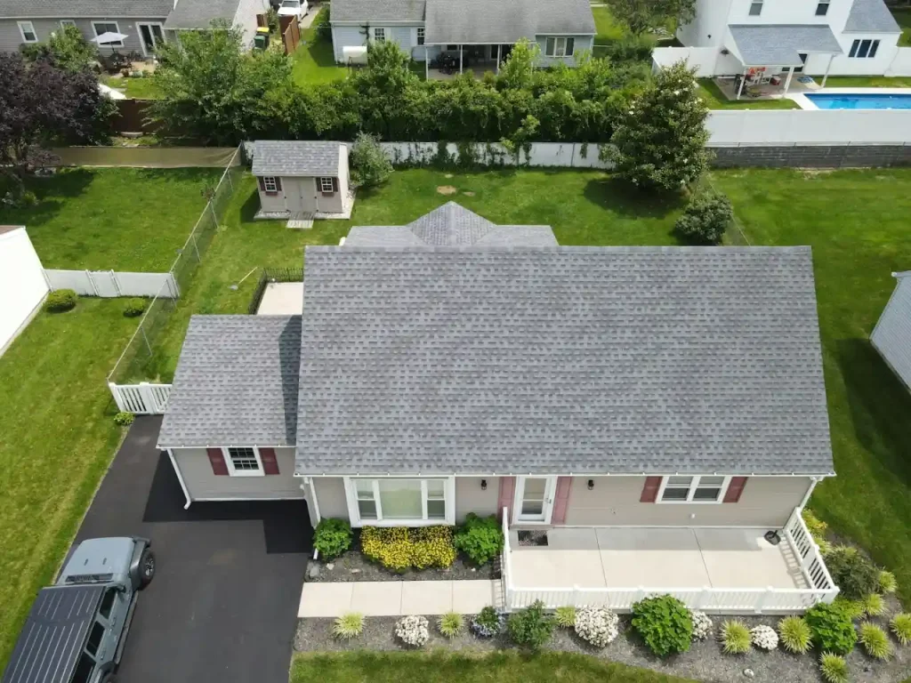 A suburban home with a clean grey asphalt shingle roof after professional roof soft washing in Indianapolis