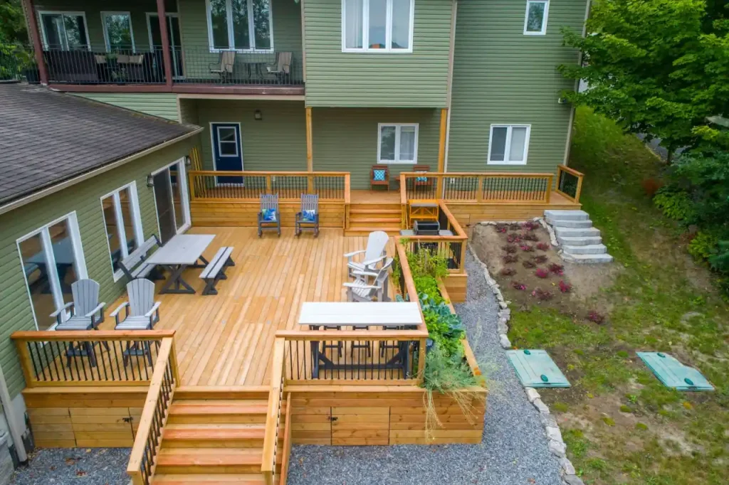 A cleaned wooden deck and patio with outdoor furniture beside a home