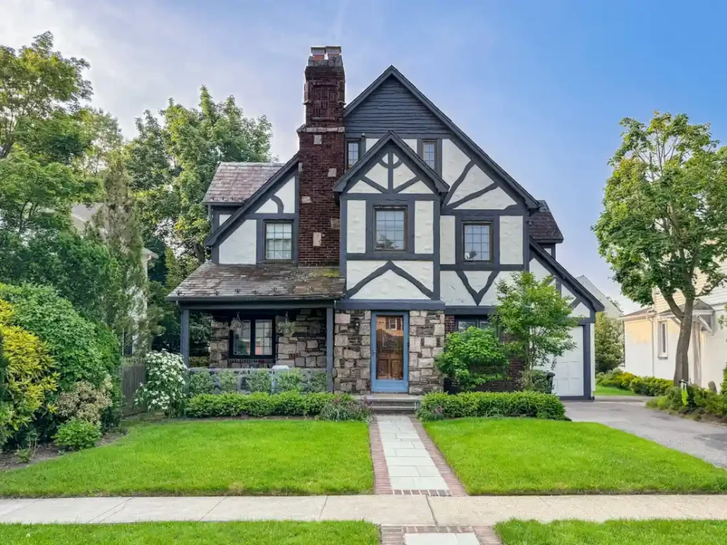 A tudor-style suburban home with a well-kept yard in Carmel, Indiana