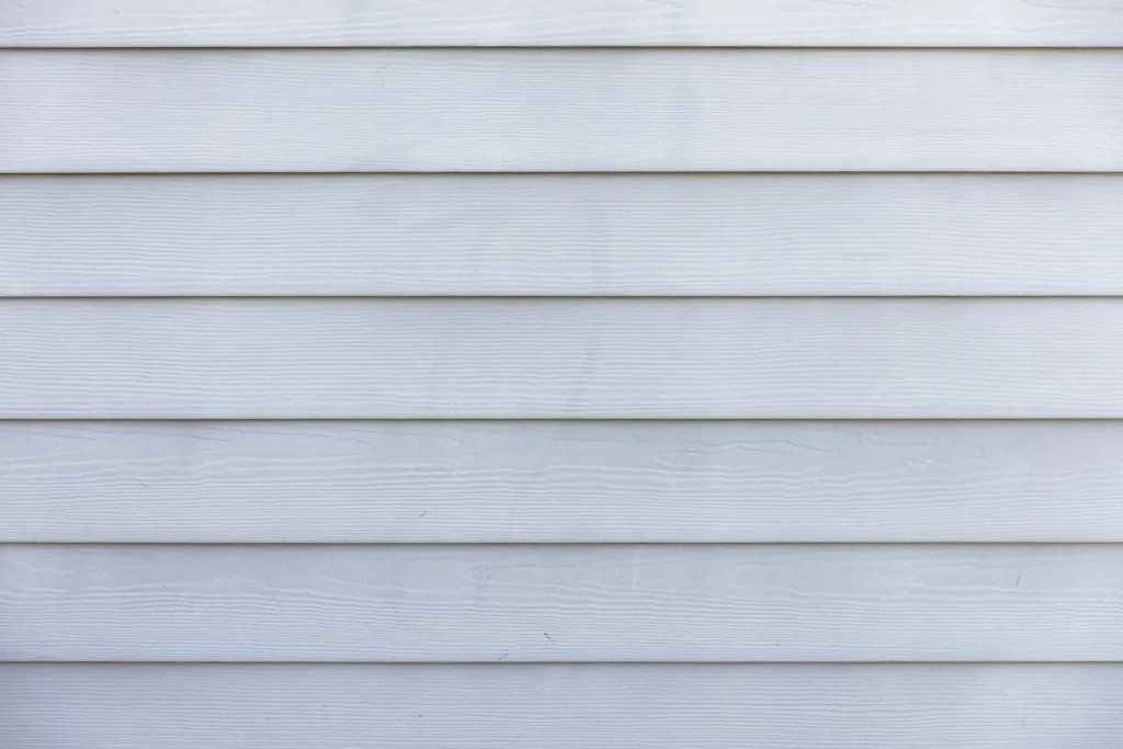 Close-up of clean white siding on a home exterior after soft washing