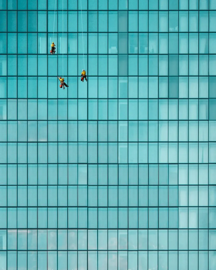 A crew cleaning exterior windows on a commercial building