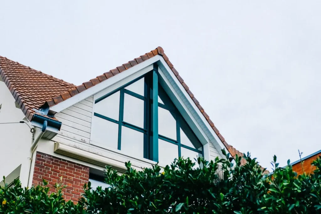 Brick house with a gabled roof and greenery