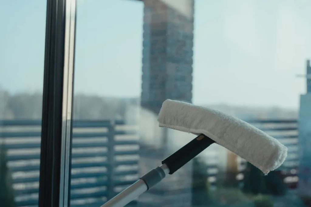 Cleaning a large glass window with a professional tool