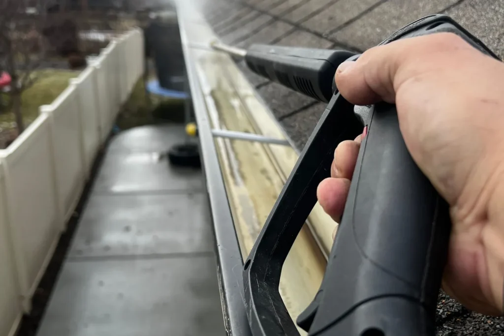Close up of gutter cleaning with a pressure washer