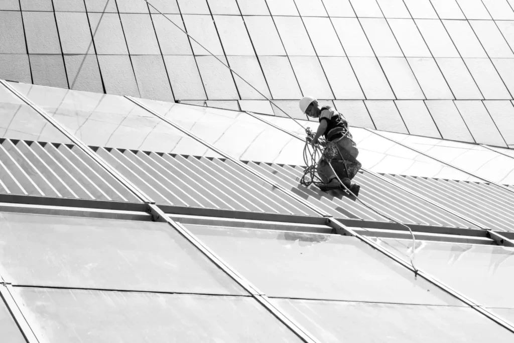 Maintenance worker cleaning a glass building facade