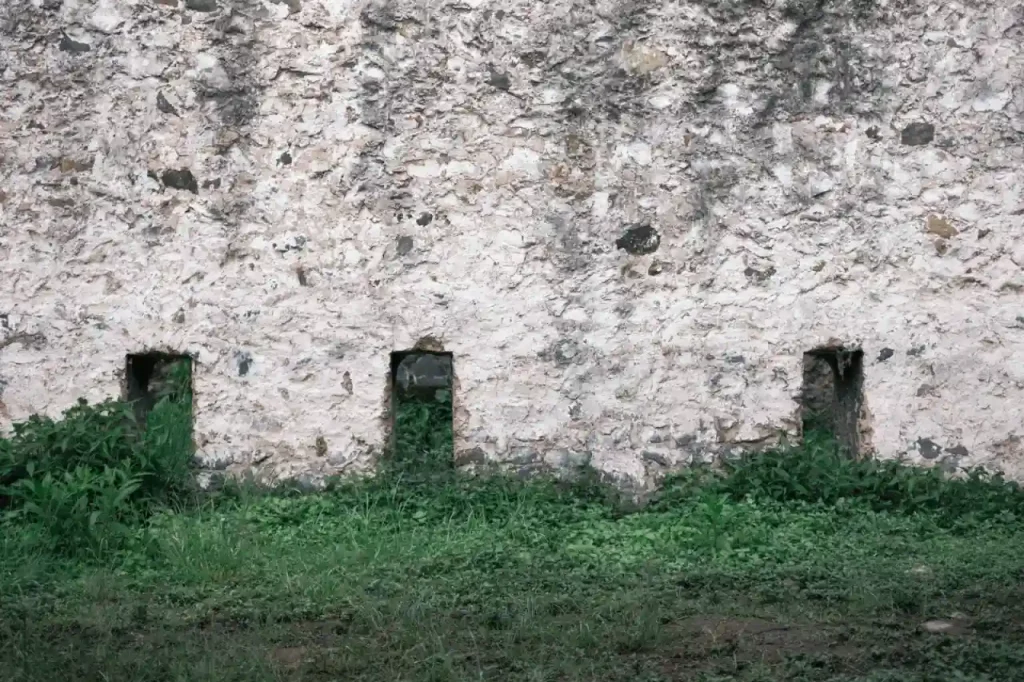 Old stone wall with small windows