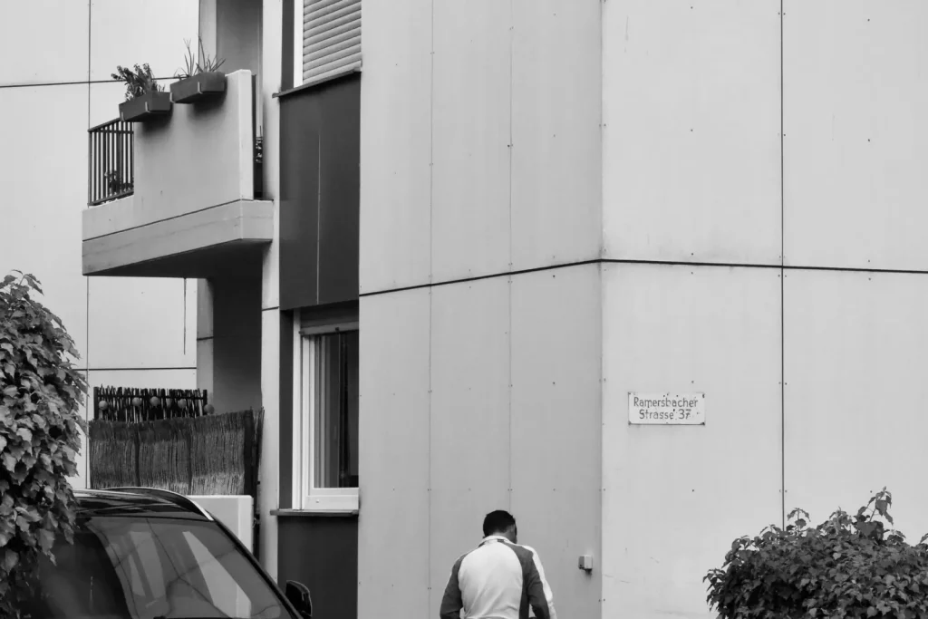 Operator power washing a building exterior
