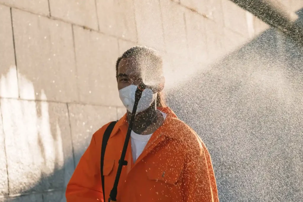 Operator spraying down an exterior wall