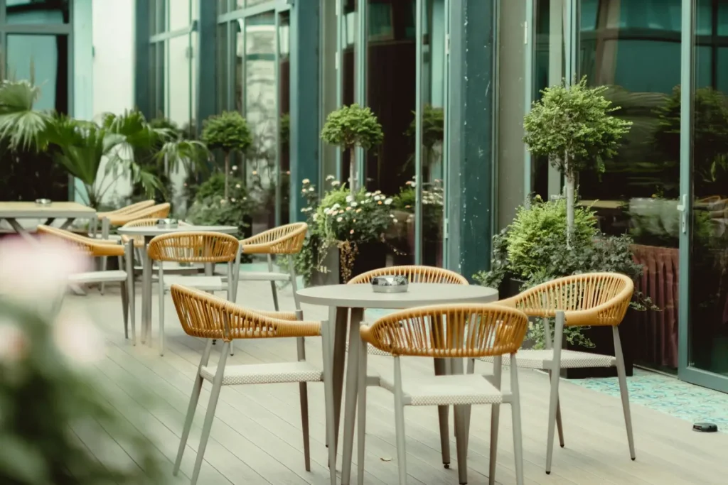 Outdoor patio with wicker chairs and greenery