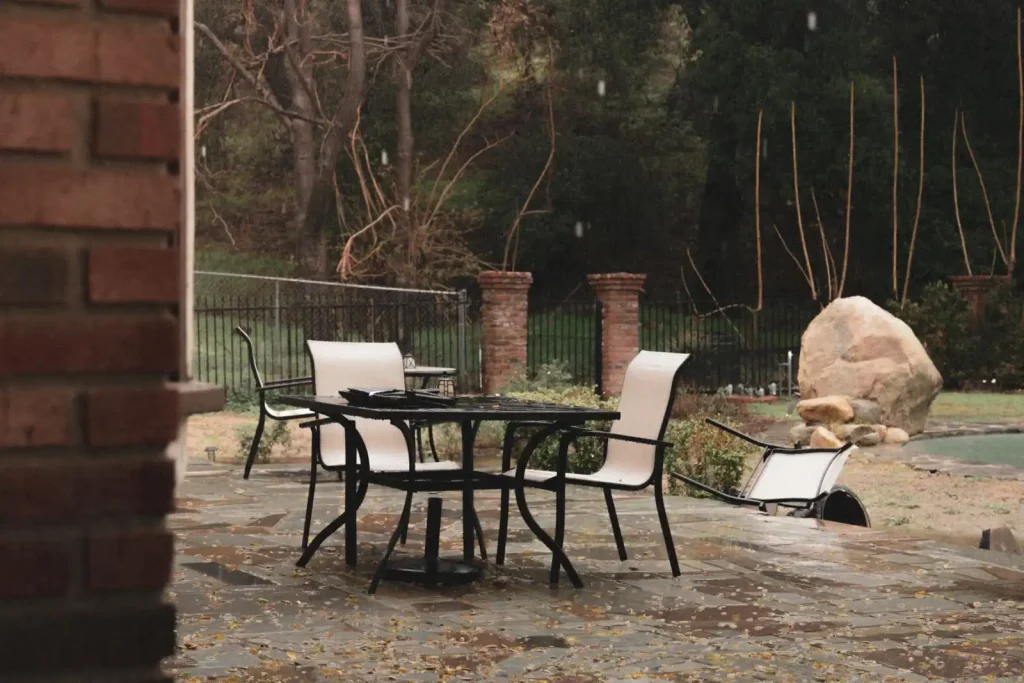 Outdoor patio with wooden table and chairs