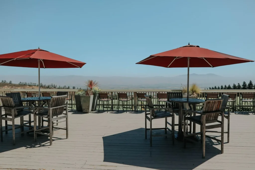 Outdoor terrace with umbrellas and wooden furniture