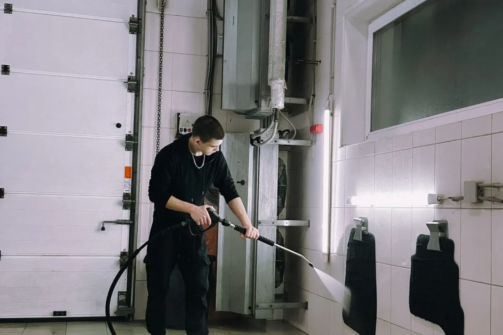 Power washing a hard surface with industrial equipment