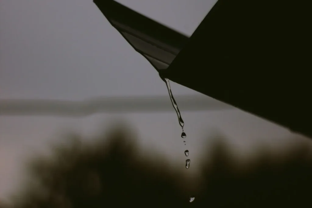 Raindrops cascading from a roof edge