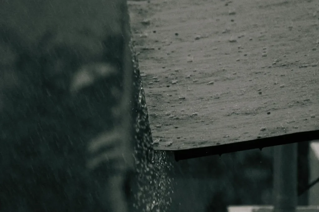 Rainwater flowing off a wooden roof