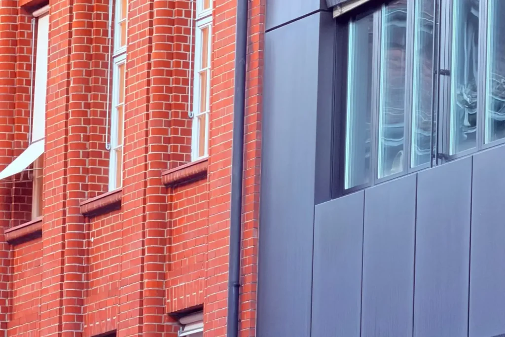 Red brick and grey metal building facade