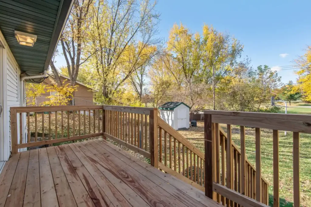 Spacious wooden deck overlooking autumn trees