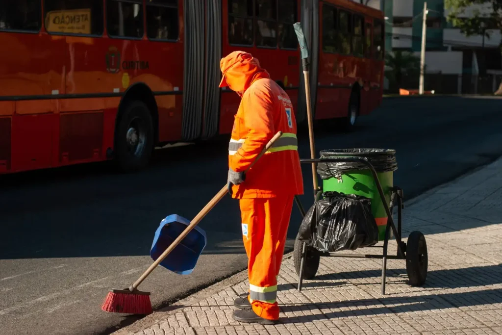 Street cleaner sweeping a sidewalk
