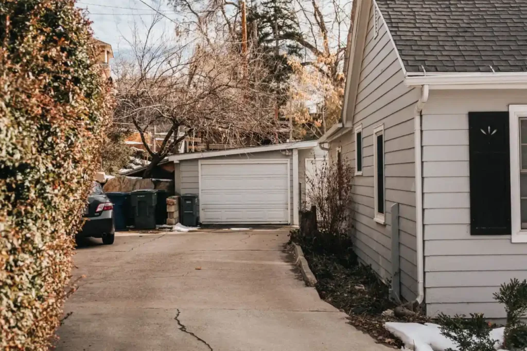 Suburban driveway with cracked and stained pavement