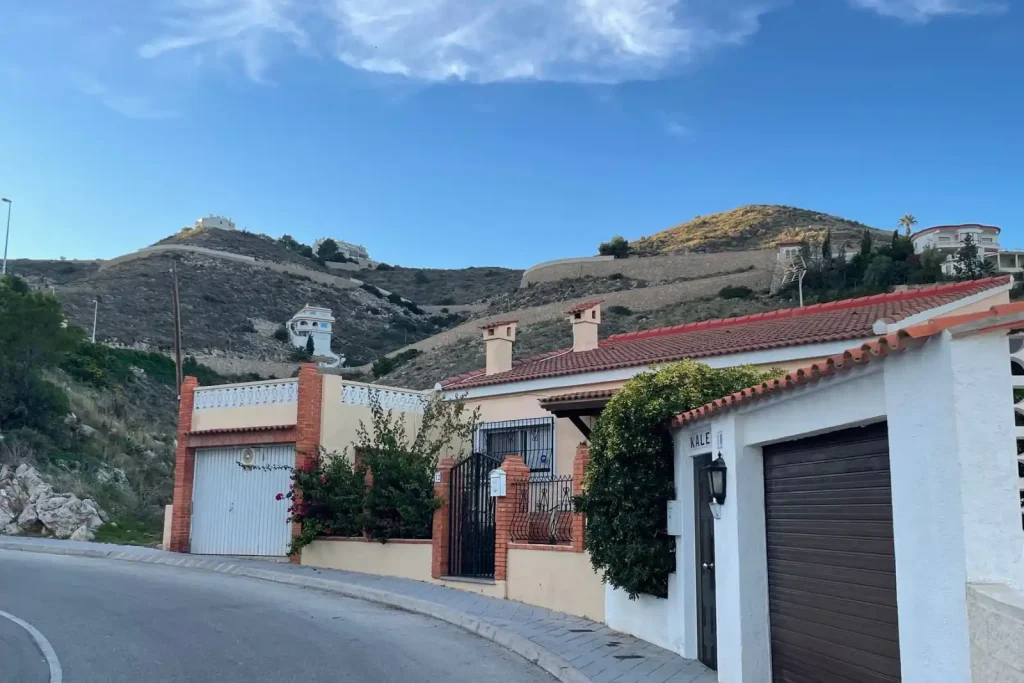 Suburban hillside street under a clear sky