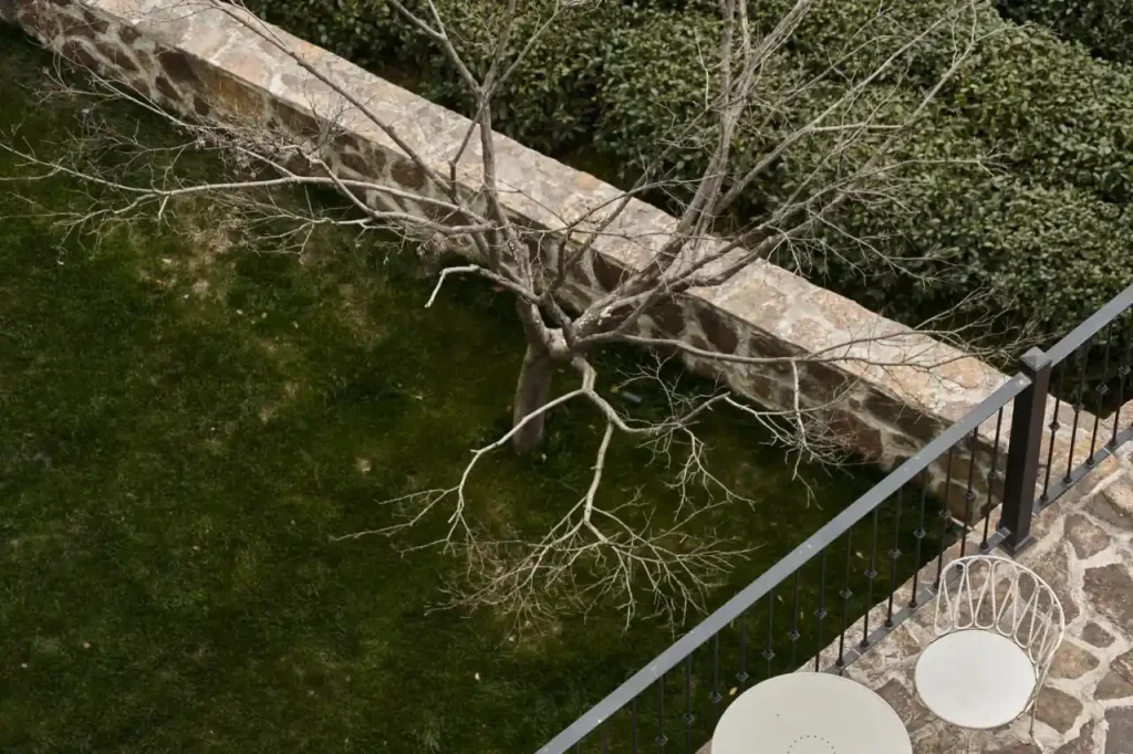 Terrace with stone flooring beside a garden