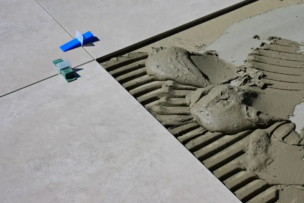 Wet cement and spacers during tile installation