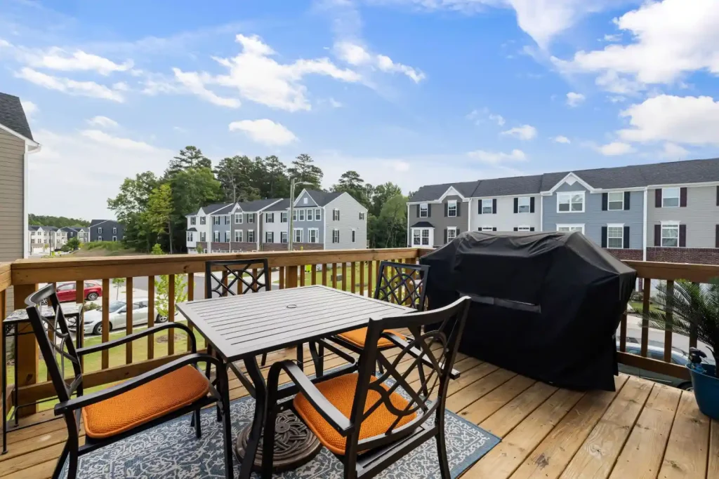 Wooden deck with outdoor furniture and grill